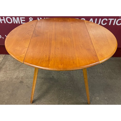 55 - An Ercol Blonde elm and beech Windsor drop-leaf table and a set of four Windsor chairs