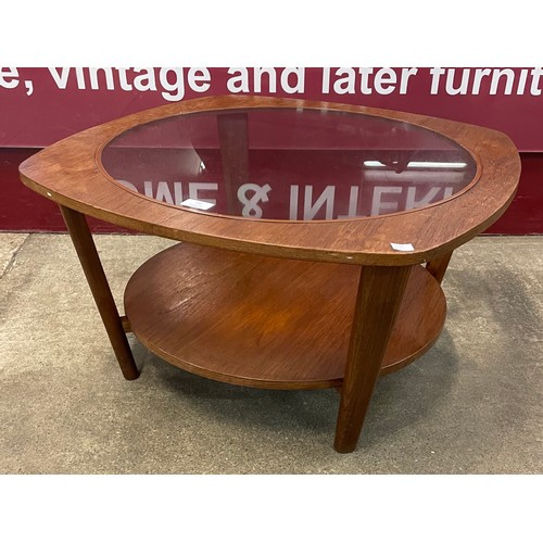 70 - A teak and glass topped coffee table