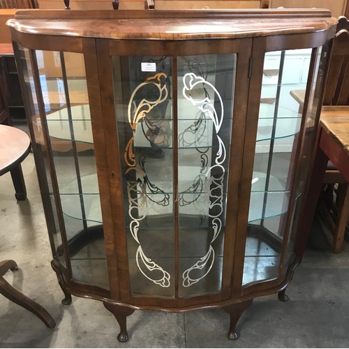 181 - A walnut single door display cabinet