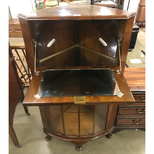 186 - An early 20th Century figured walnut corner cocktail cabinet