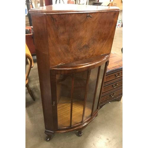 186 - An early 20th Century figured walnut corner cocktail cabinet