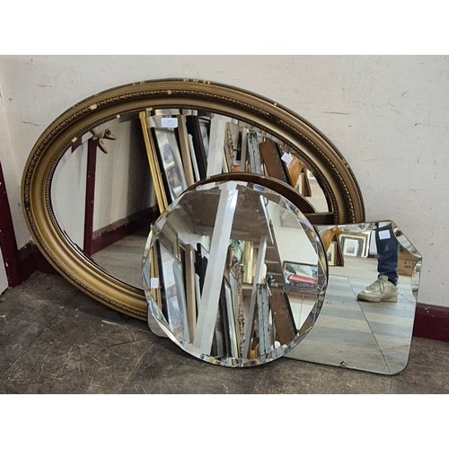 292 - A Victoran style gilt framed oval framed mirror and two bevelled edged mirrors