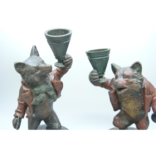 2015 - A pair of painted bronze wolf themed candlesticks