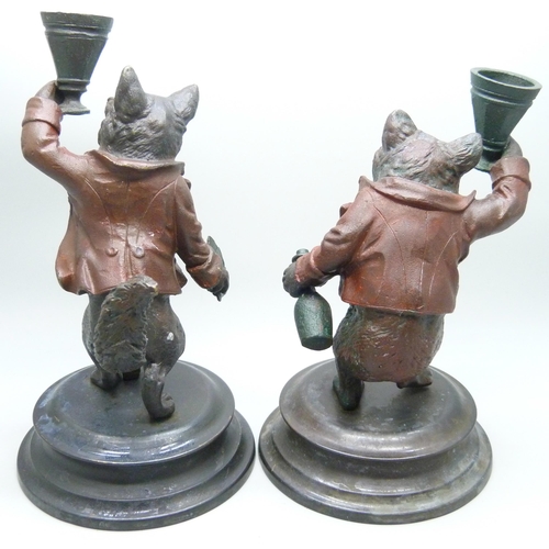 2015 - A pair of painted bronze wolf themed candlesticks