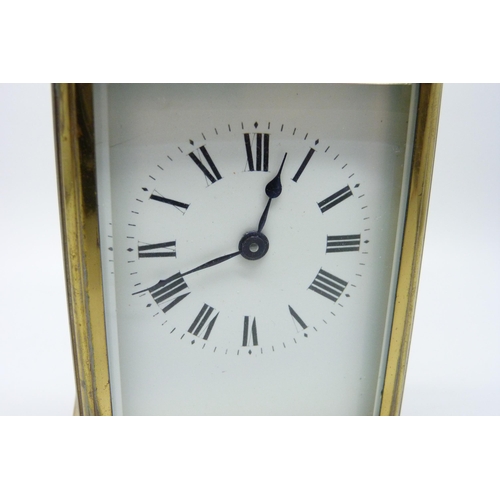 2019 - A brass carriage clock with carry handle and key, 11cm