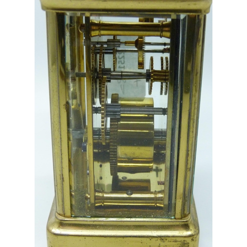 2019 - A brass carriage clock with carry handle and key, 11cm