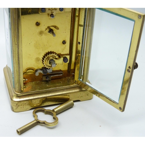 2019 - A brass carriage clock with carry handle and key, 11cm