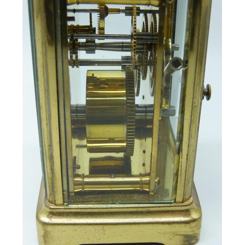 2019 - A brass carriage clock with carry handle and key, 11cm