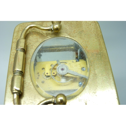 2019 - A brass carriage clock with carry handle and key, 11cm