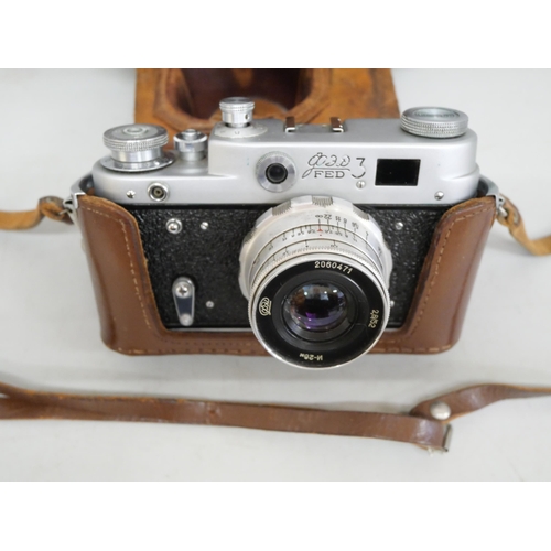 2084 - A vintage Russian 35mm camera with a leather case