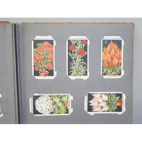 2135 - A stamp album and Player's cigarette cards album