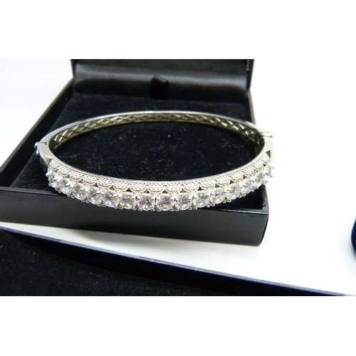 2214 - A silver ring, silver bracelet with flower buds and a platinum bonded white stone bracelet