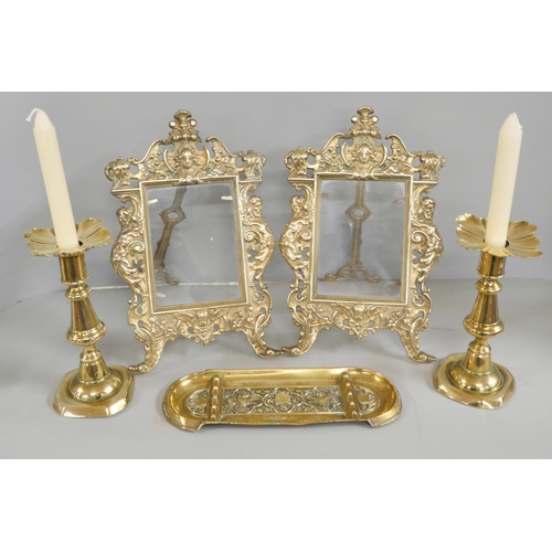 2251 - A pair of antique style brass photograph frames, a brass pen tray and a pair of brass candlesticks