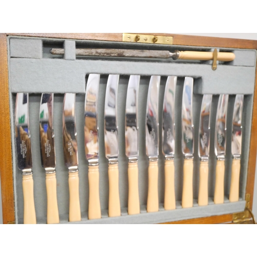 2264 - A walnut canteen of silver plated cutlery, knives with faux ivory handles