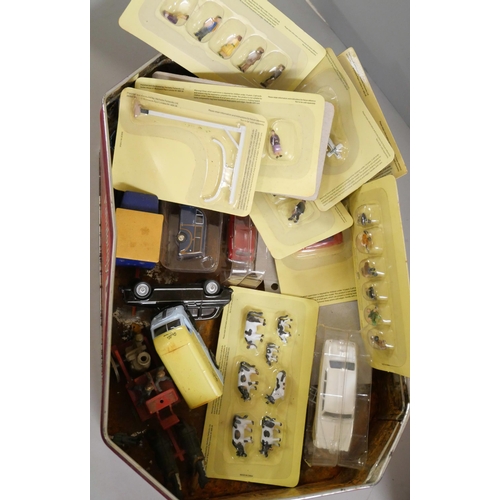 2269 - A tin of plated cutlery and a tin of model vehicles and model rail figures and vehicles