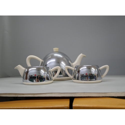 2320 - A green glass dressing table set and a chrome covered pottery tea service **PLEASE NOTE THIS LOT IS ... 