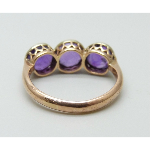 7001 - A 9ct gold ring set with three amethysts, early 20th Century Chester mark, 2.5g, size I, possibly re... 