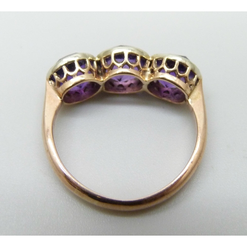 7001 - A 9ct gold ring set with three amethysts, early 20th Century Chester mark, 2.5g, size I, possibly re... 