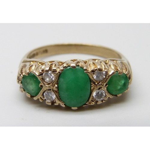 7009 - A 9ct gold, emerald and white stone ring, 3.6g, P