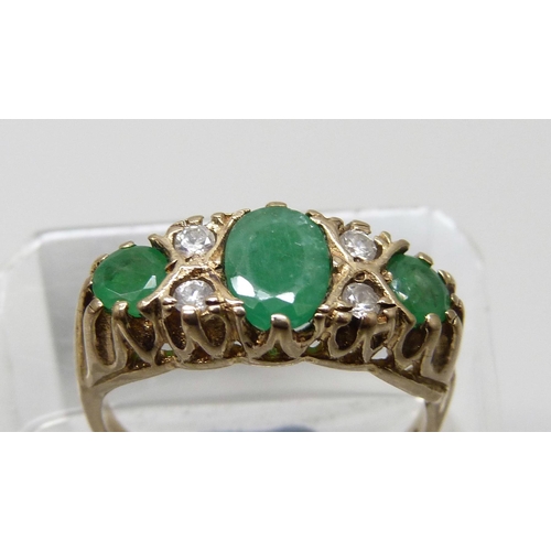 7009 - A 9ct gold, emerald and white stone ring, 3.6g, P