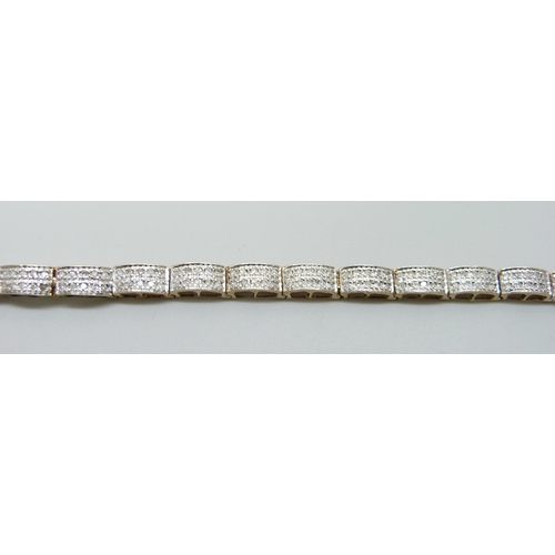 7012 - A 9ct gold and diamond bracelet, 12.4g, 18cm, lacking two stones