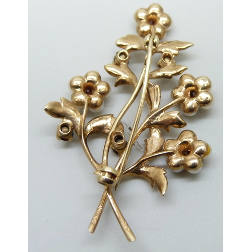 7013 - A 9ct gold, seed pearl and garnet flower spray brooch, 8.6g, 52mm