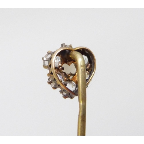 7017 - A yellow metal stick pin with white stones and heart shaped pearl, cased, 1g