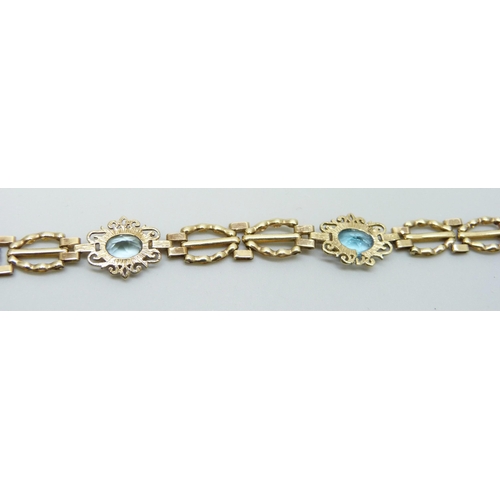 7023 - A 9ct gold and blue topaz bracelet, 5.8g, 17.5cm