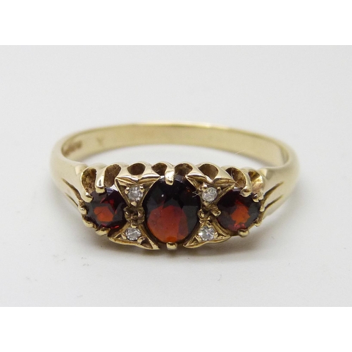 7025 - A 9ct gold, Victorian style garnet and diamond ring, 2.2g, P