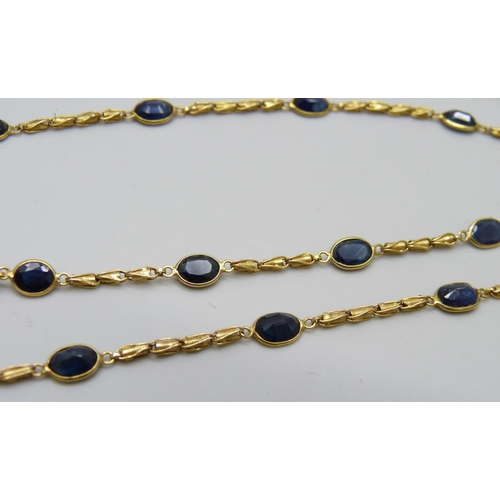 7029 - An 18ct gold and blue stone necklace, 9g, 66cm