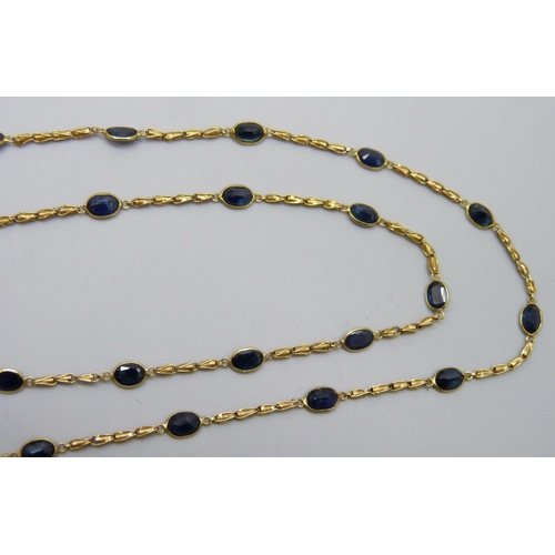 7029 - An 18ct gold and blue stone necklace, 9g, 66cm