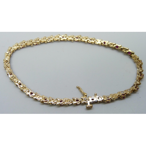 7033 - A 9ct gold, ruby and diamond bracelet, 7.3g, 19.5cm