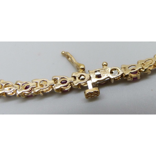 7033 - A 9ct gold, ruby and diamond bracelet, 7.3g, 19.5cm