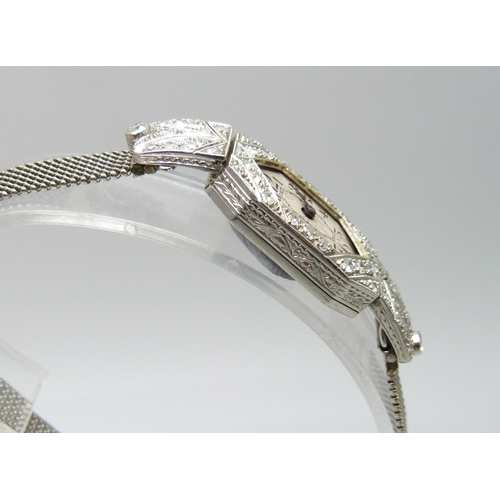 7044 - A platinum and diamond set cocktail wristwatch on a 9ct white gold bracelet strap, weight without mo... 