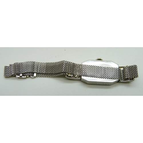 7044 - A platinum and diamond set cocktail wristwatch on a 9ct white gold bracelet strap, weight without mo... 