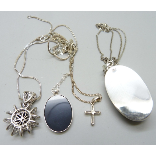 7064 - Four silver pendants and chains