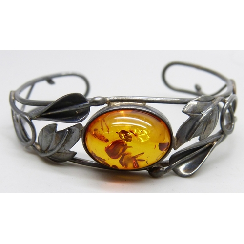 7068 - A silver and amber bangle and a silver and citrine brooch