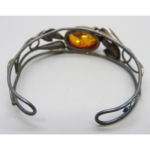 7068 - A silver and amber bangle and a silver and citrine brooch