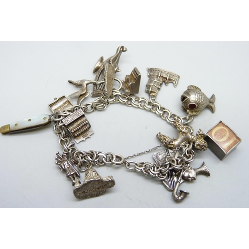 7071 - A silver charm bracelet, 45g