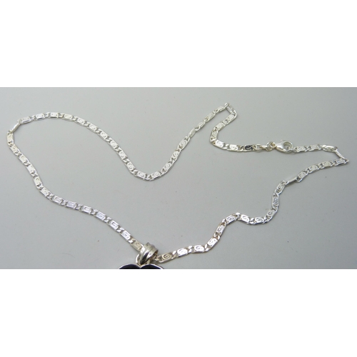 7091 - A silver and onyx pendant and chain