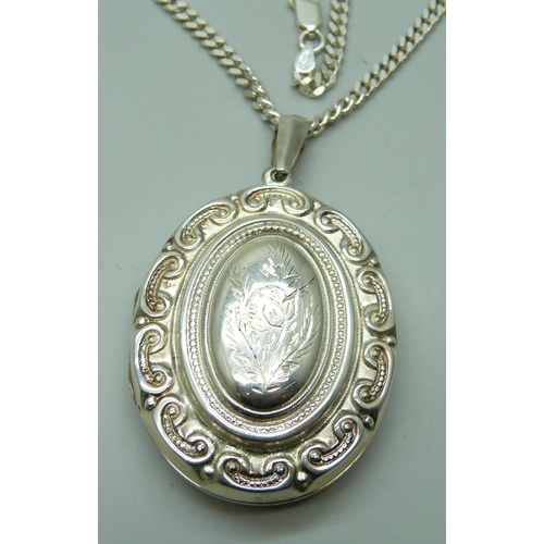 7094 - A silver locket and chain, 36g, chain 50cm