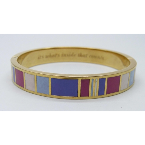 7122 - A gilt metal designer bangle by Kate Spade, New York