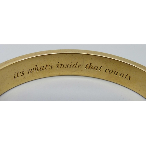 7122 - A gilt metal designer bangle by Kate Spade, New York