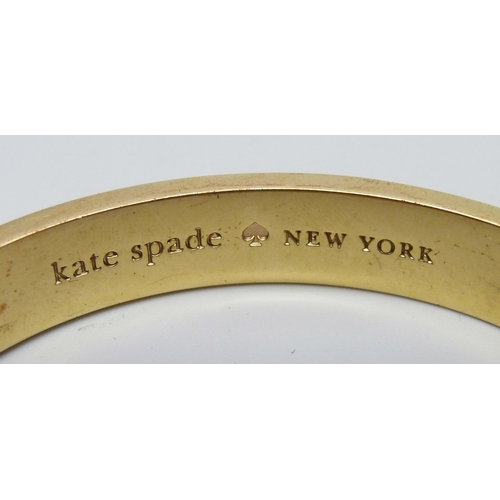 7122 - A gilt metal designer bangle by Kate Spade, New York