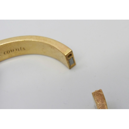 7122 - A gilt metal designer bangle by Kate Spade, New York