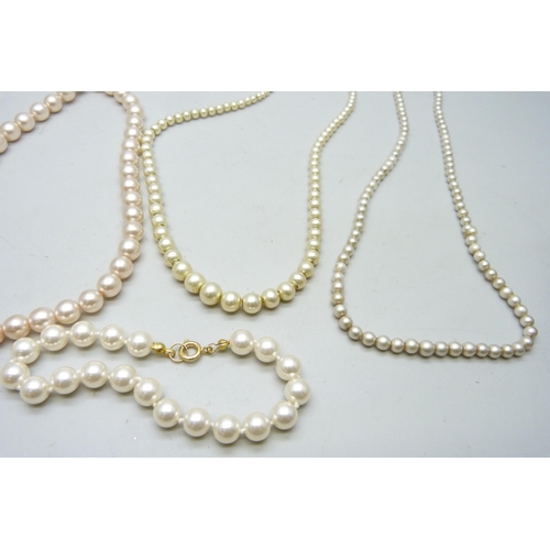 7138 - Four faux pearl necklaces and a bracelet