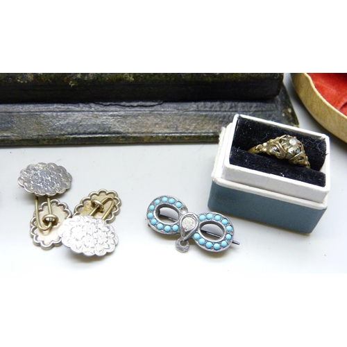 7142 - A white metal pill box with monogram, two turquoise set brooches, a pair of white metal fronted cuff... 