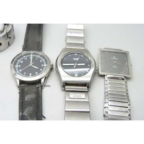 7160 - A collection of lady's and gentleman's wristwatches to include Storm, Swiss Military, Titan Edge, Ci... 