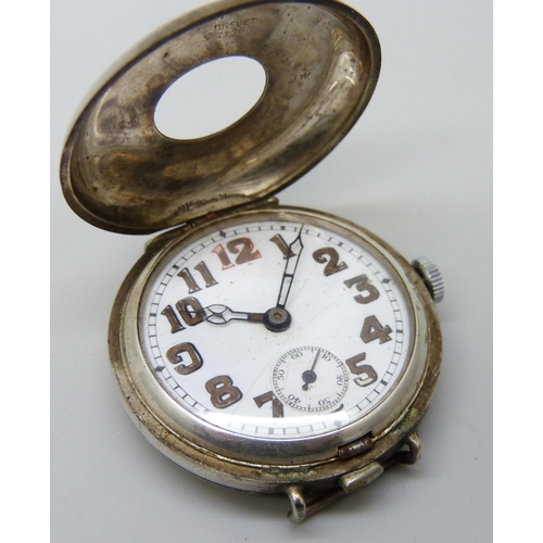 7170 - A silver half-hunter trench wristwatch, button release flip open case front, Glasgow import mark for... 