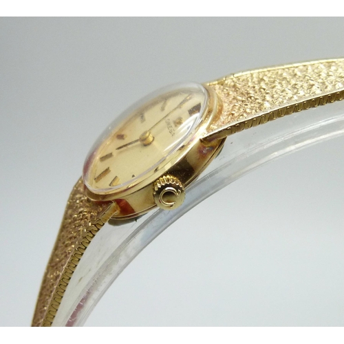 7213 - A lady's 9ct gold Omega wristwatch, with box and papers, total weight 18.6g